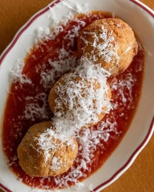 Golden bites in rich tomato sauce, finished with grated cheese at La Prima